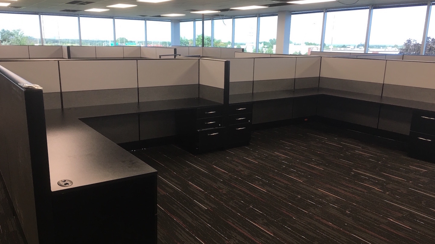 Cubicle walls and desks installed in the empty office.